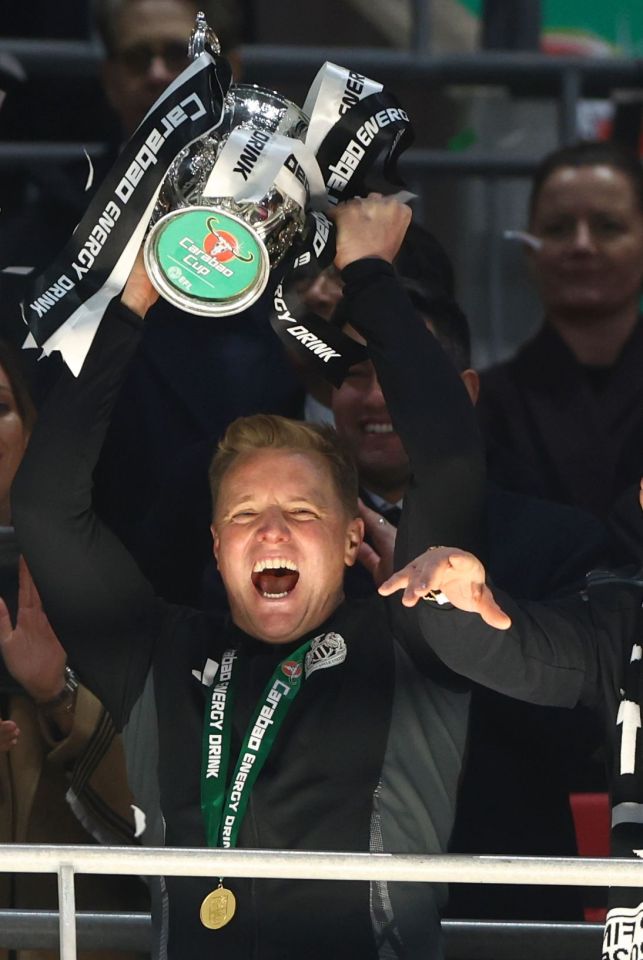 Newcastle United manager Eddie Howe lifts the Carabao Cup trophy.