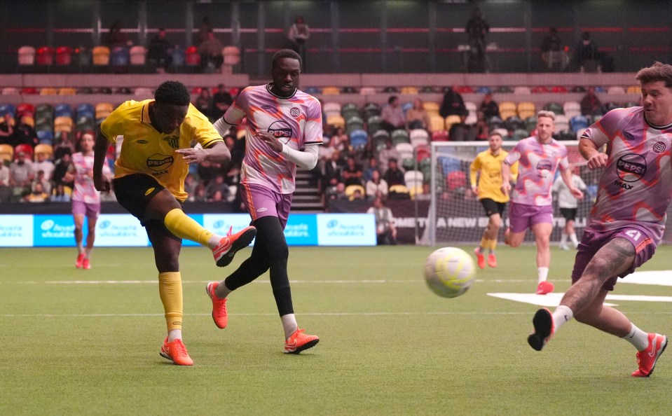 Soccer player kicking the ball during a game.