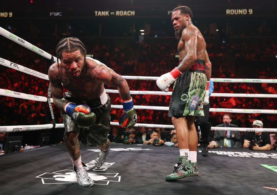 Gervonta Davis kneeling in a boxing ring during a match.