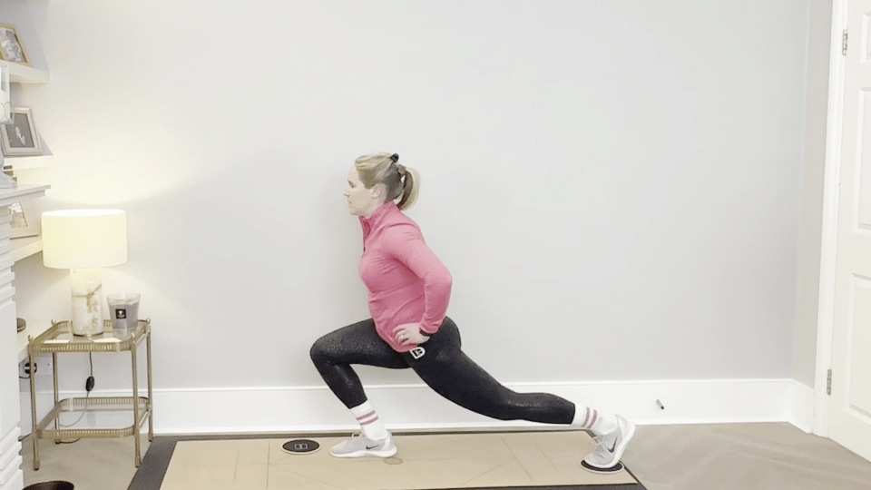Woman performing a core-strengthening slider exercise.