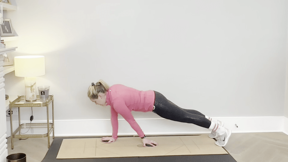 Woman performing a core-strengthening slider exercise.