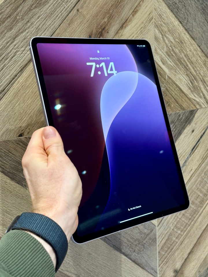 Hand holding iPad Air 2025.