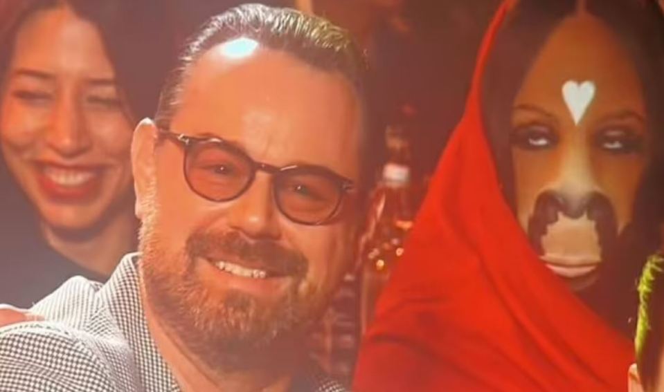 Danny Dyer sitting next to a person in a horse costume.