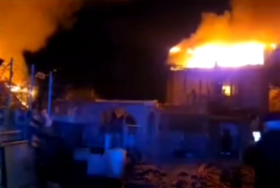 Building engulfed in flames at night.