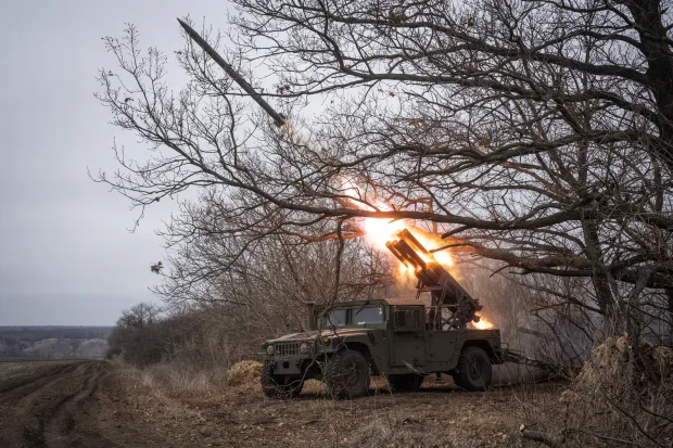 Military vehicle firing a rocket.