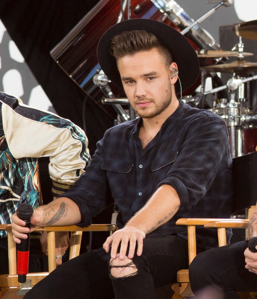 Liam Payne sitting in a chair.