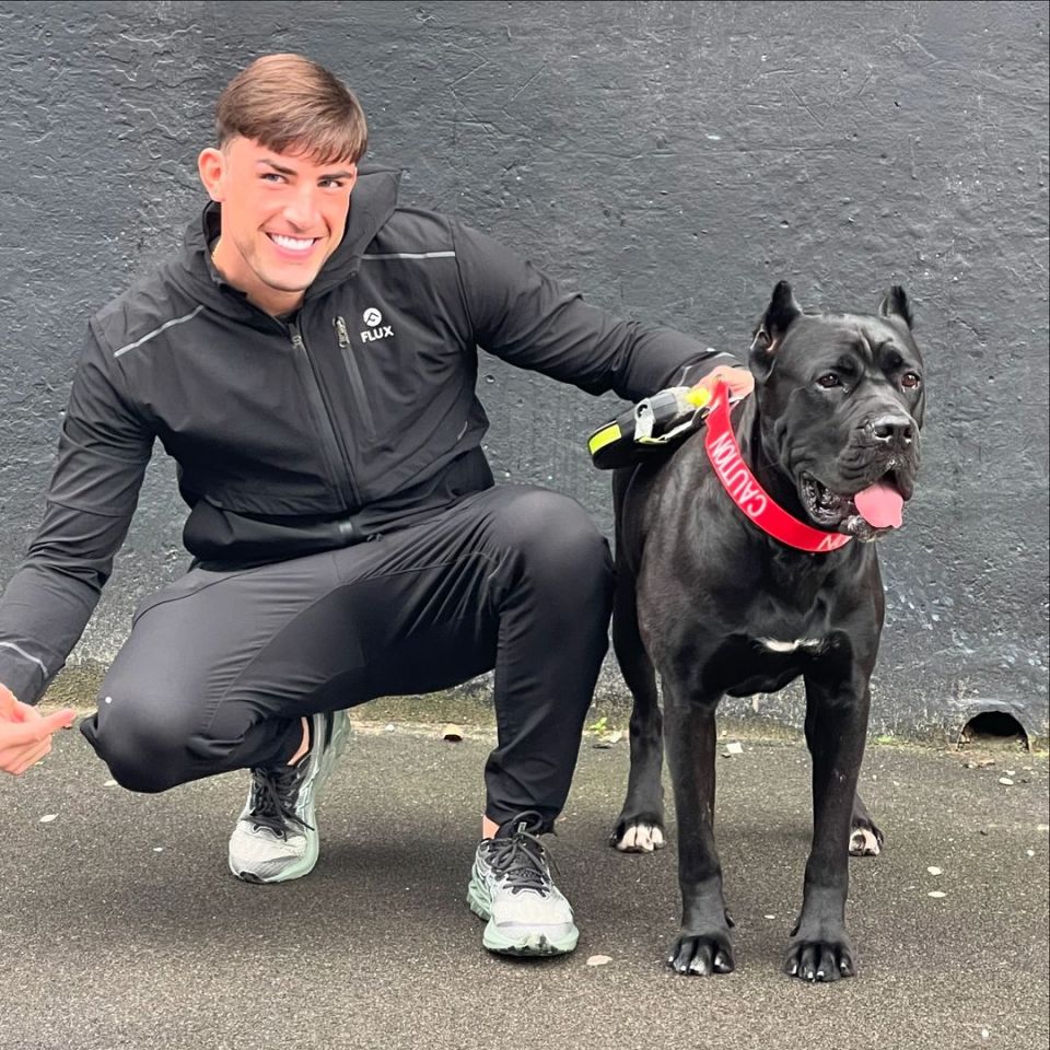 Jack Fincham crouching with his dog.