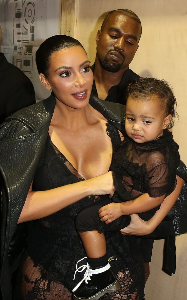 Kim Kardashian, Kanye West, and North West at the Givenchy Paris Fashion Week show.
