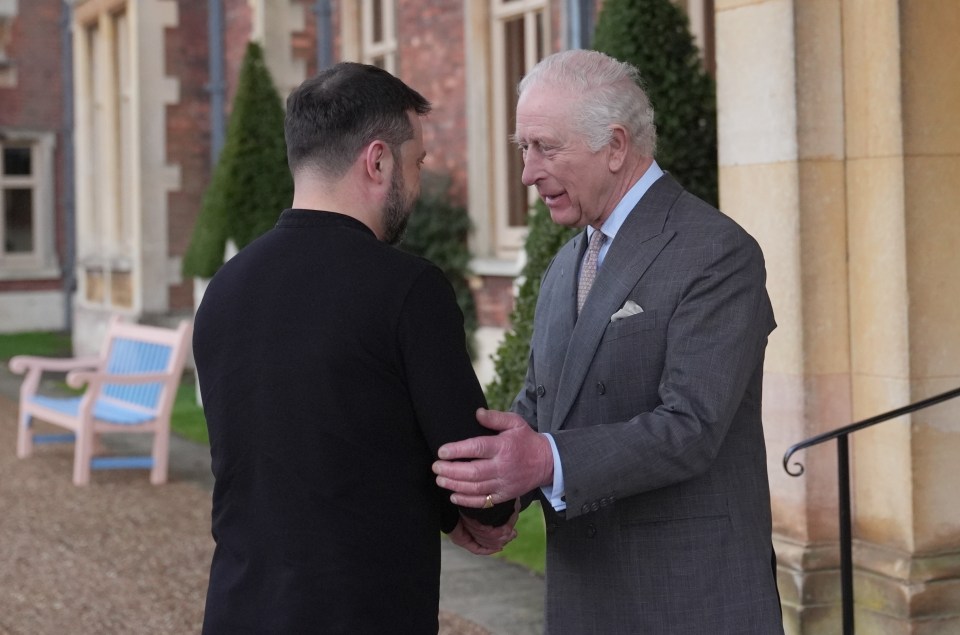 King Charles III shaking hands with Ukrainian President Volodymyr Zelensky.