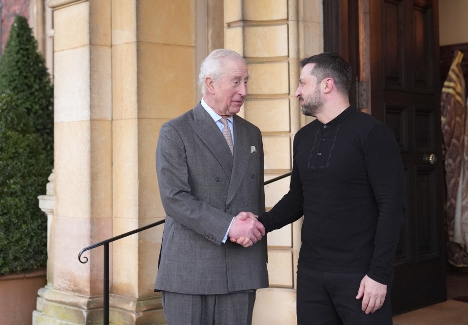 King Charles III shaking hands with Ukrainian President Volodymyr Zelensky.