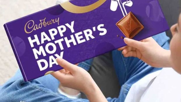 Person holding a Cadbury Happy Mother's Day chocolate bar.