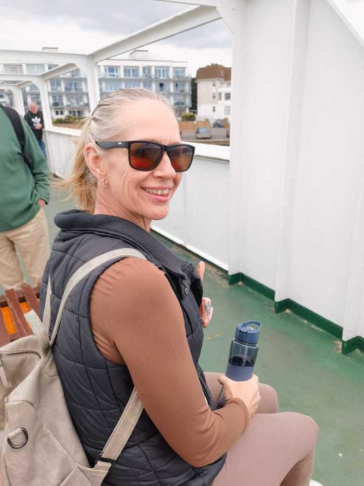 Woman on a ferry giving a thumbs up.