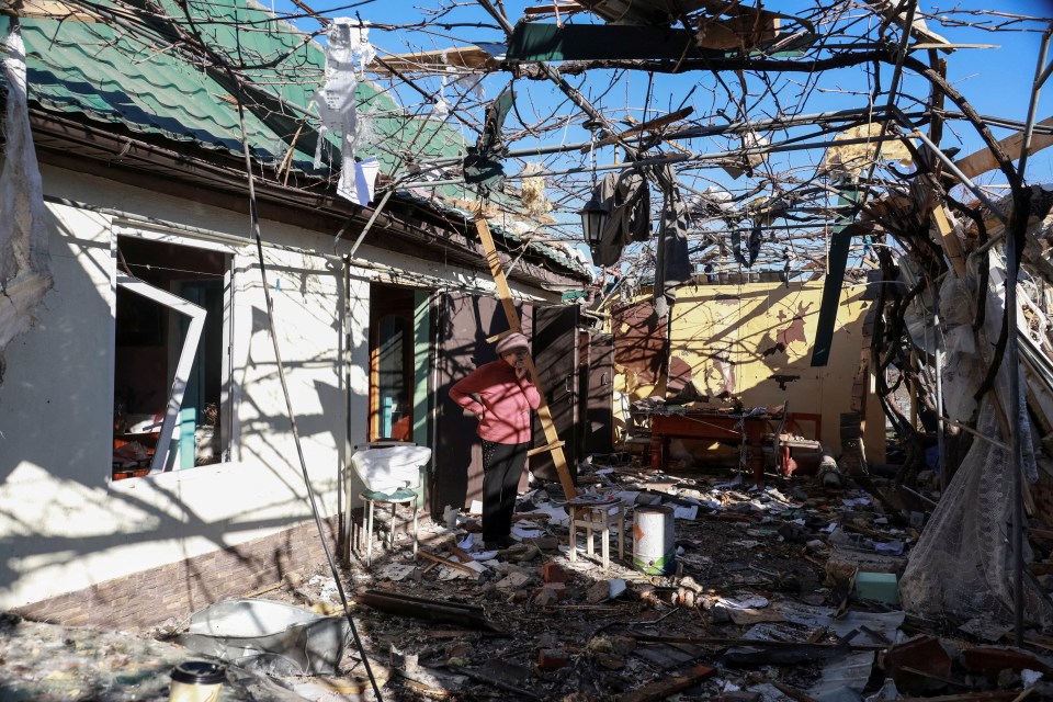 A resident stands amidst the debris of a drone-strike-destroyed house near Odesa, Ukraine.