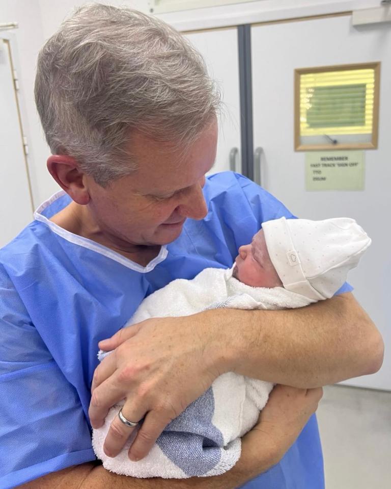 A man holding his newborn daughter.