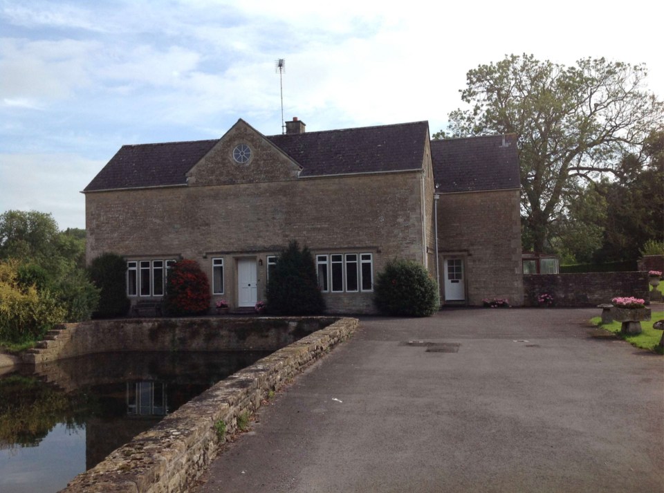 Stone house near a pond.