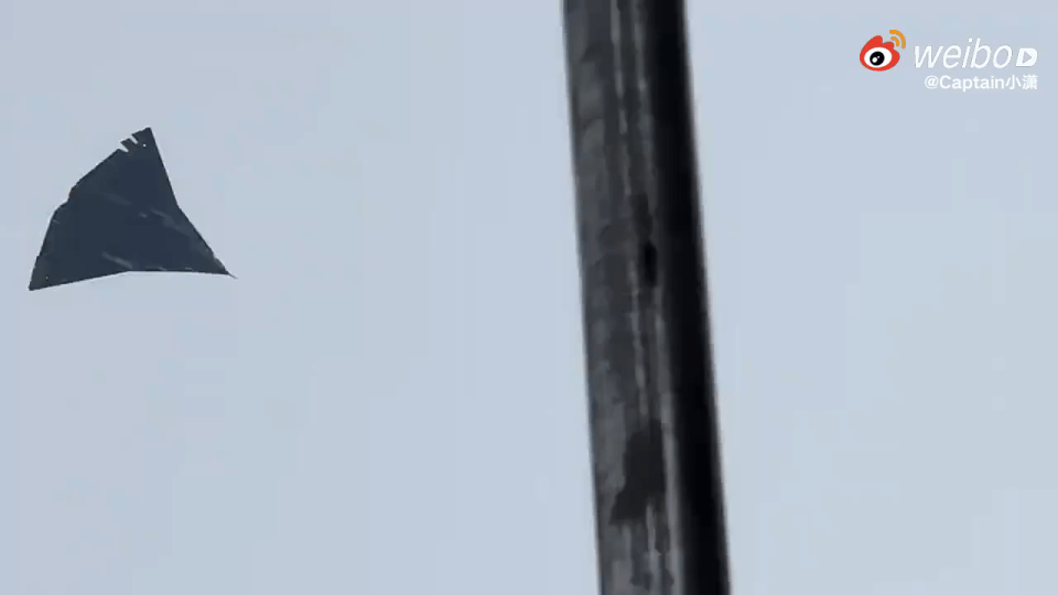 Photo of a dark, triangular object in the sky.