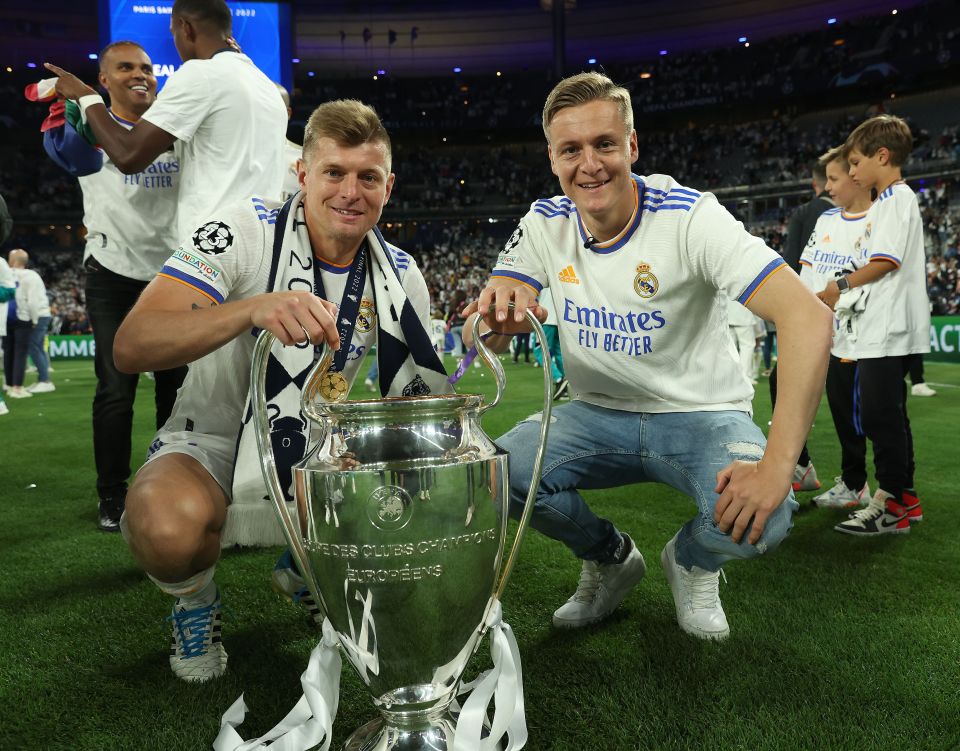 Toni Kroos and his brother with the UEFA Champions League trophy.