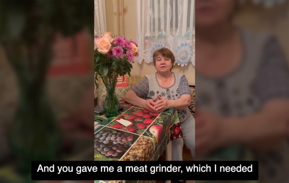 A woman sits at a table, talking about receiving a meat grinder.