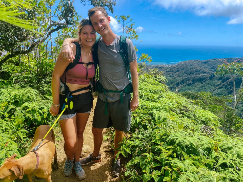Couple hiking with their dog in Hawaii.