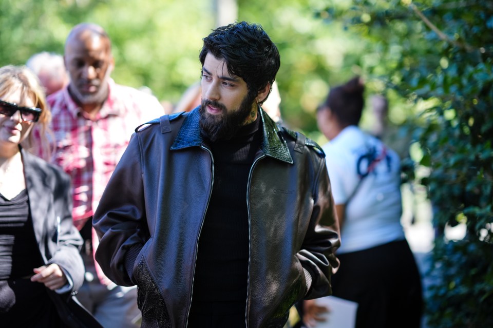 Zayn Malik wearing a dark brown leather bomber jacket at New York Fashion Week.