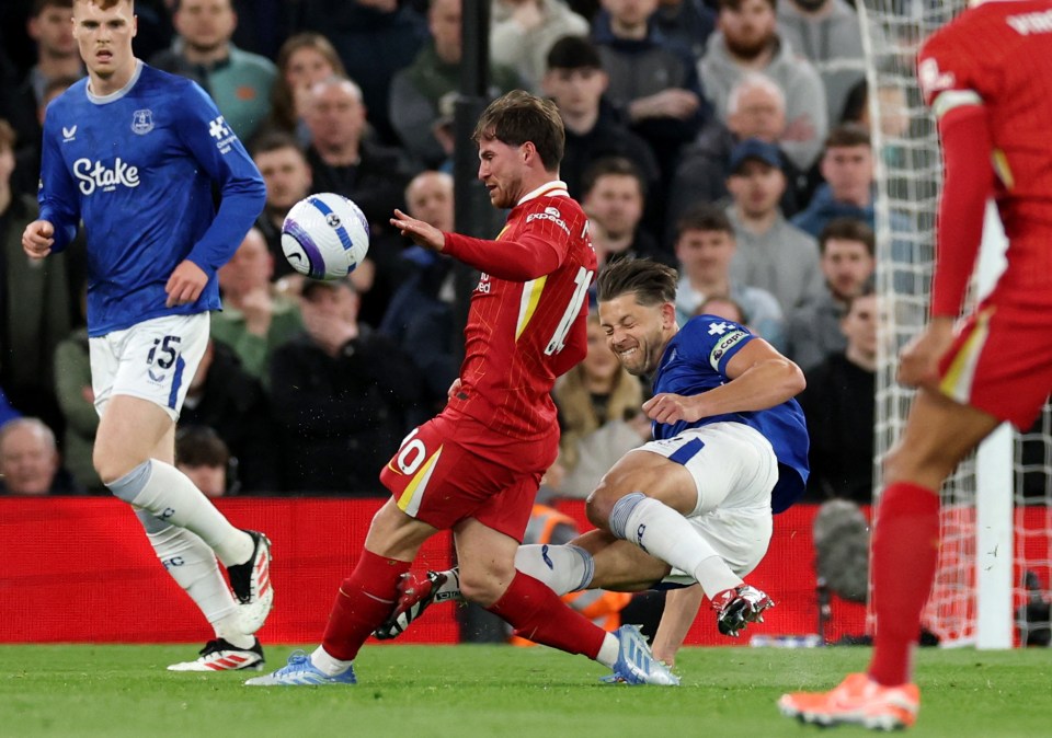Liverpool's Alexis Mac Allister and Everton's James Tarkowski vying for the ball.