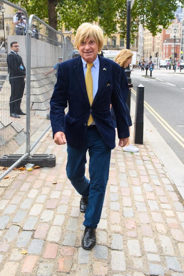 Michael Fabricant walking on a cobblestone street.