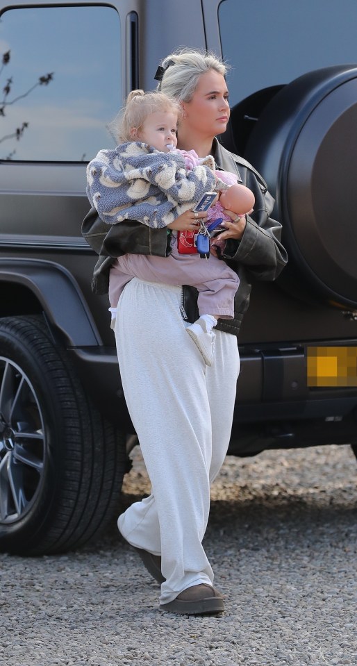 Molly Mae Hague walking with her daughter and a doll.