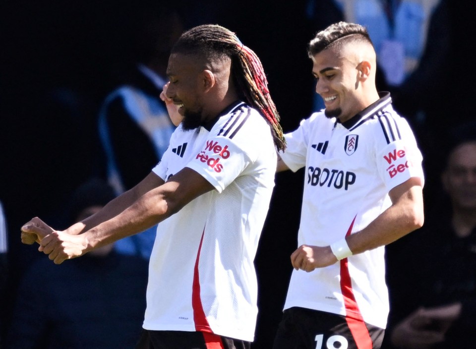 Fulham's Alex Iwobi and Andreas Pereira celebrating a goal.
