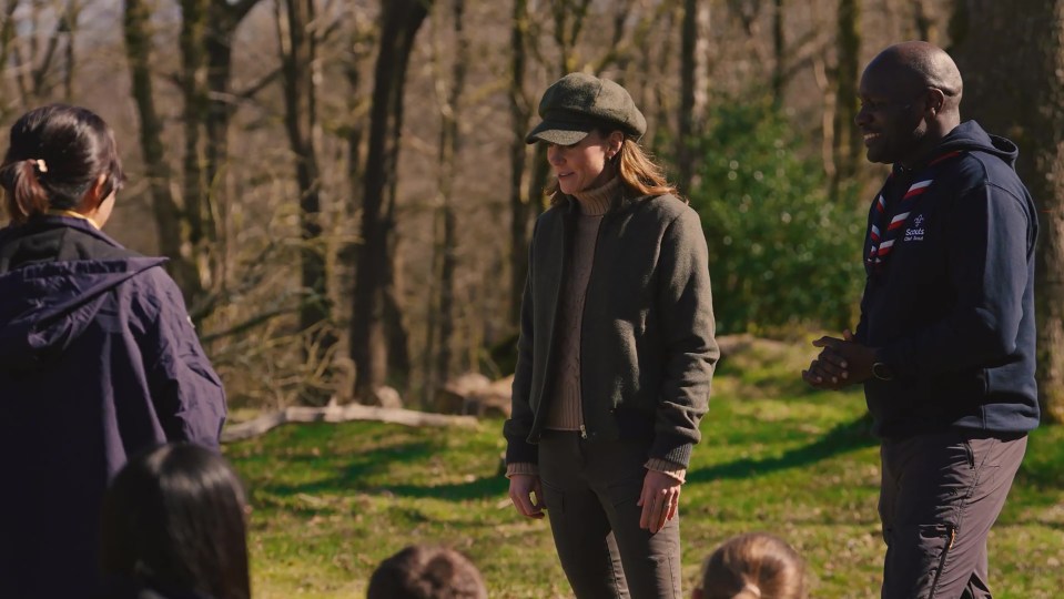 Screengrab from a film showing Kate Middleton, Princess of Wales, and the Chief Scout discussing the benefits of nature with a group of Scouts.