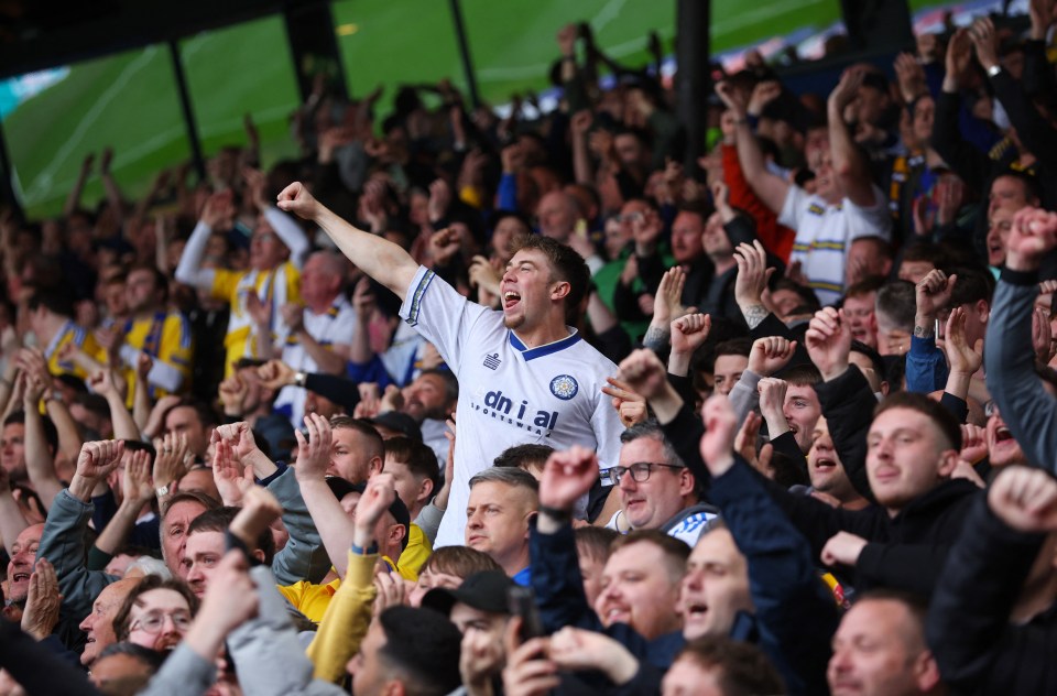 Leeds United fans celebrating in the stands.
