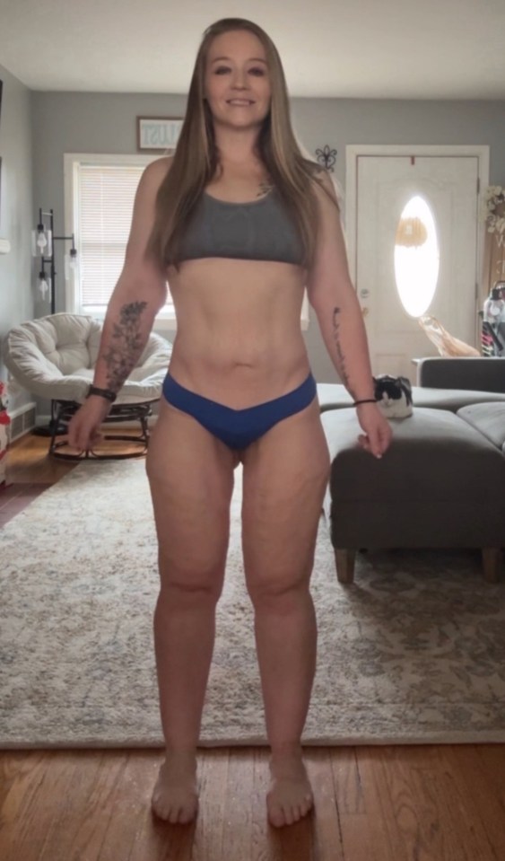 Woman standing in her underwear showing her legs.