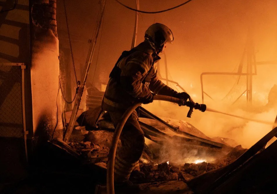Firefighter extinguishing a fire in a building.