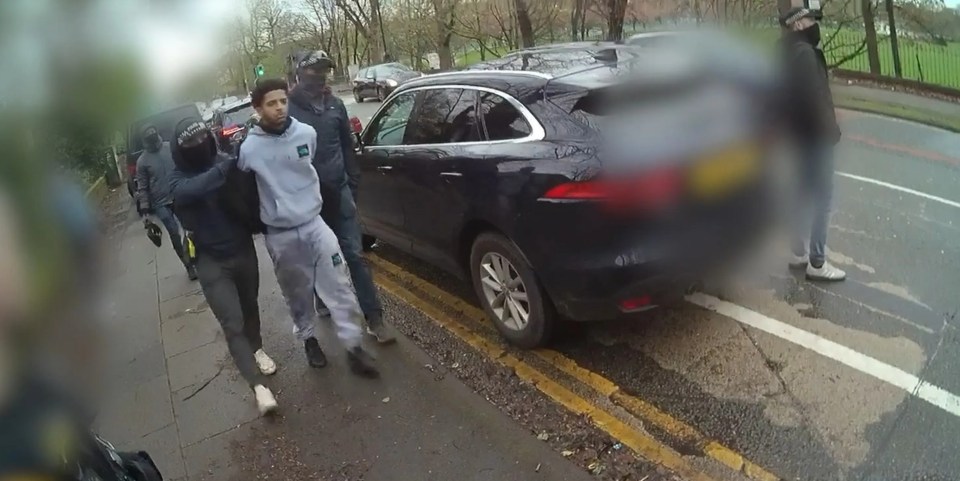 Police officers arresting a suspect.