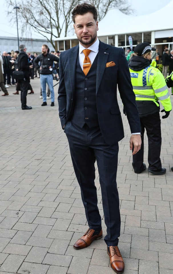 Man in suit at a horse race.