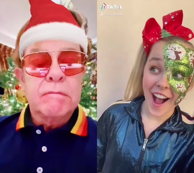 Elton John wearing a Santa hat and JoJo Siwa with a Christmas face paint.
