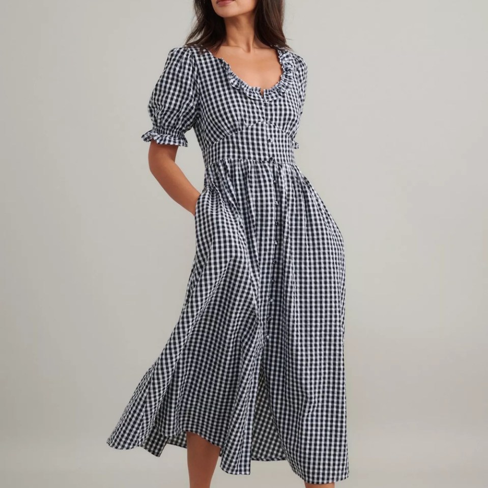 Black and white gingham midi dress with puff sleeves and pockets.