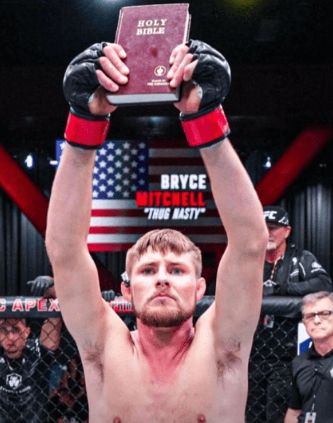 Bryce Mitchell holding a Bible aloft after a fight.