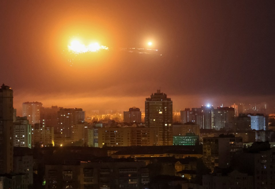 Missile exploding over a city at night.