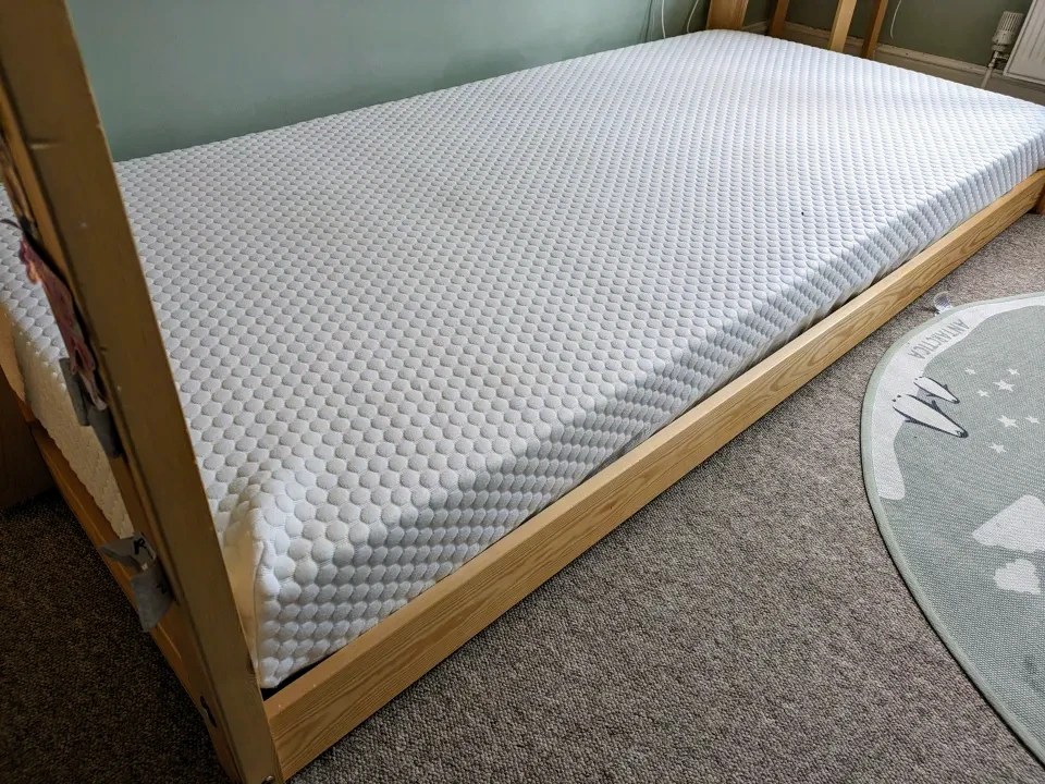 Single mattress on a wooden frame.