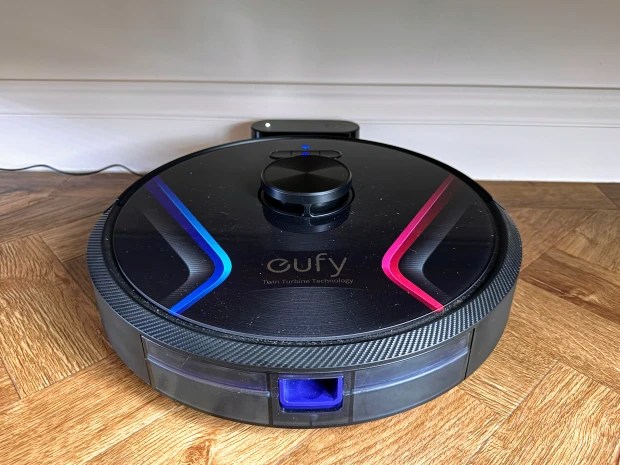 Eufy RoboVac X8 robot vacuum cleaner on hardwood floor.