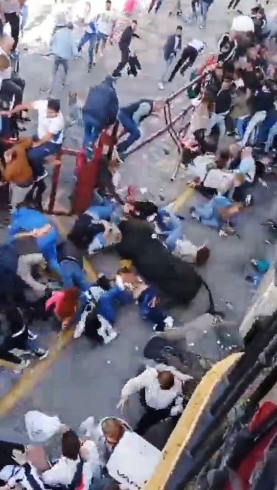 A bull charging through a crowd of people.