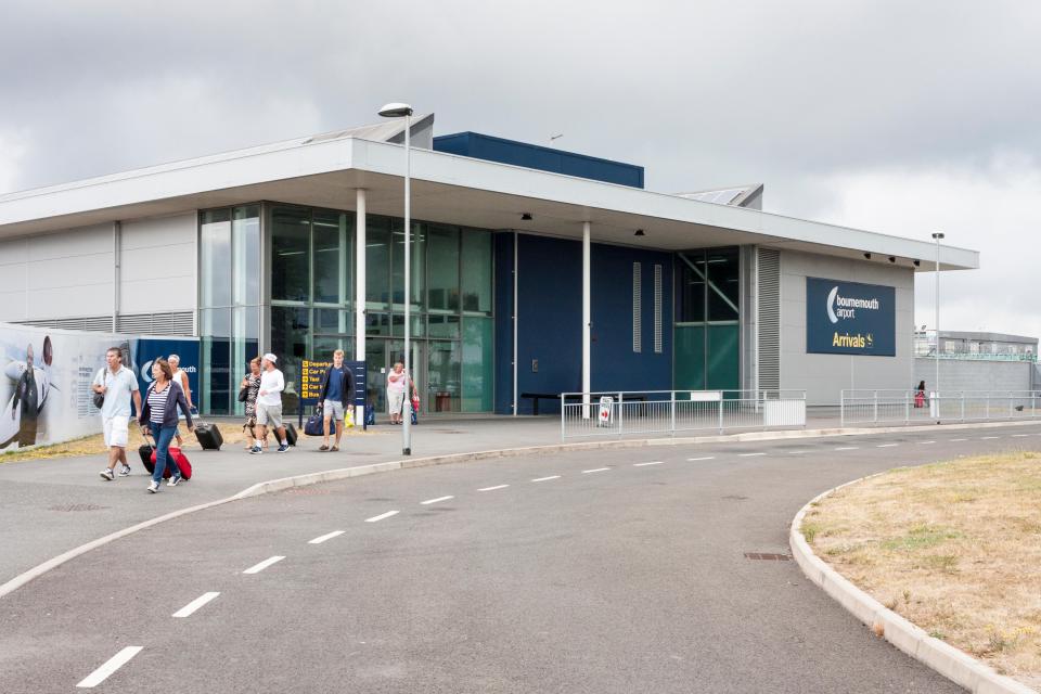 Bournemouth Airport arrivals terminal with passengers.