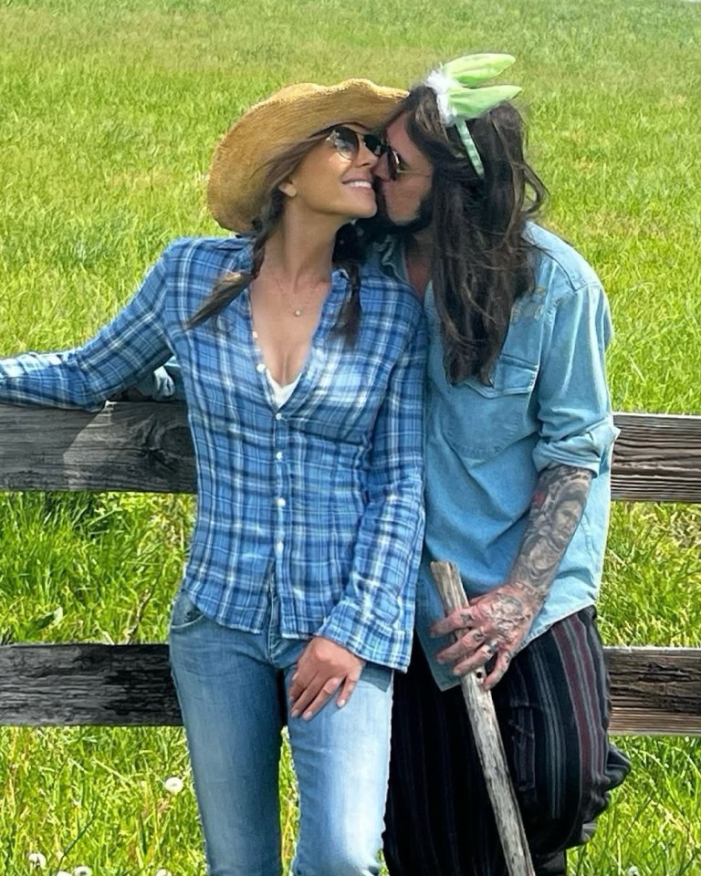 Elizabeth Hurley and Billy Cyrus kissing in a field.
