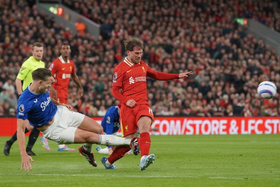 James Tarkowski fouling Alexis Mac Allister during a Liverpool vs Everton soccer match.