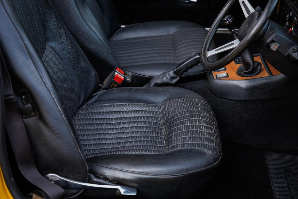 Close-up of black leather bucket seats in a 1977 Triumph Stag.