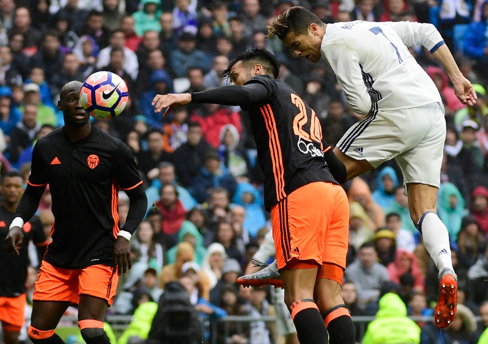 Cristiano Ronaldo heading a soccer ball during a game.