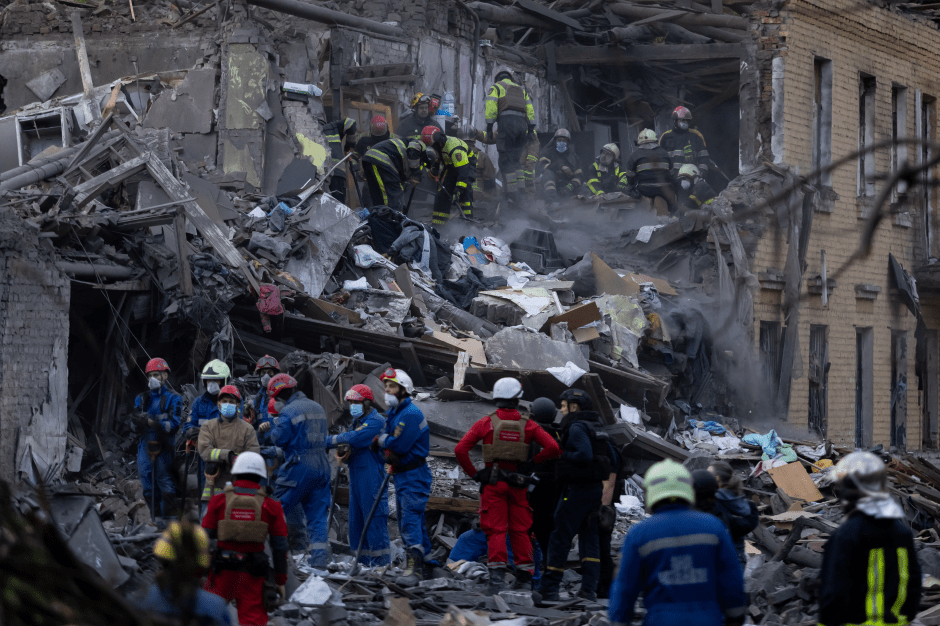 Emergency responders at a destroyed building.