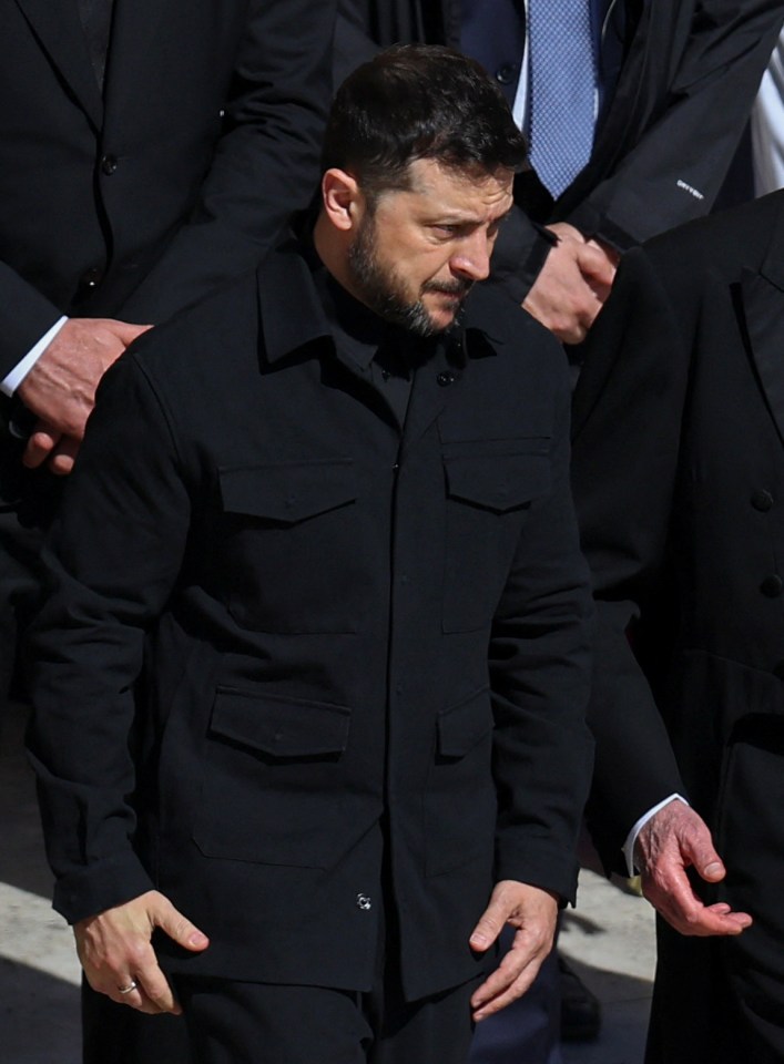 Man in black jacket at a funeral.