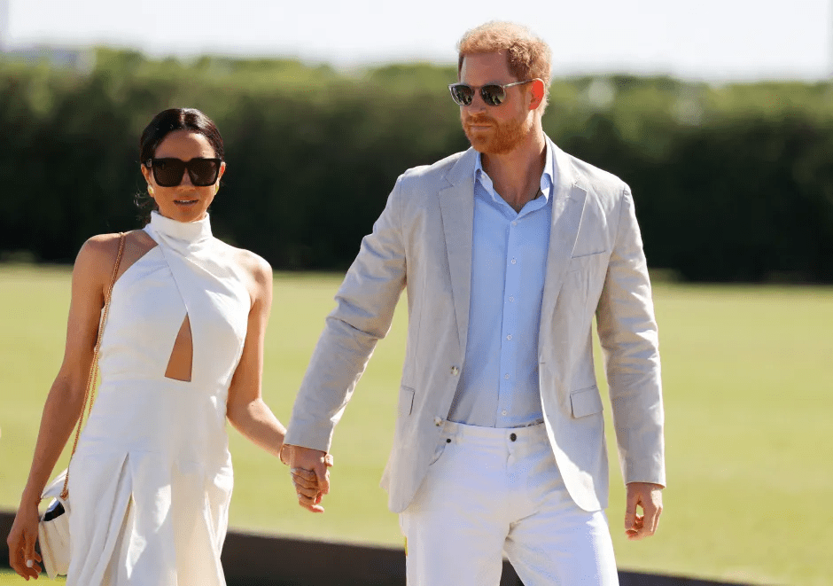 Prince Harry and Meghan Markle holding hands.