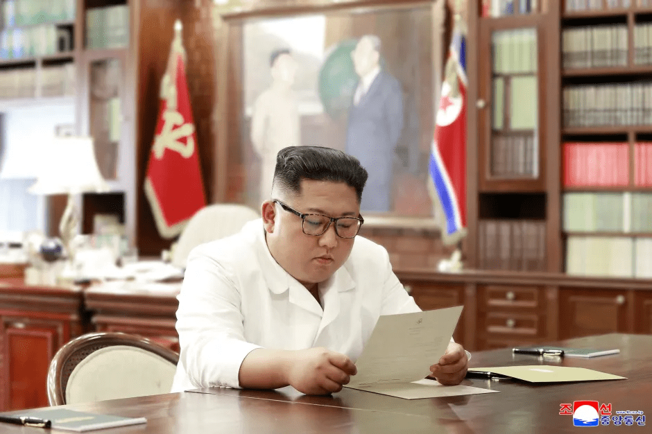 Kim Jong-un reviewing documents at his desk.